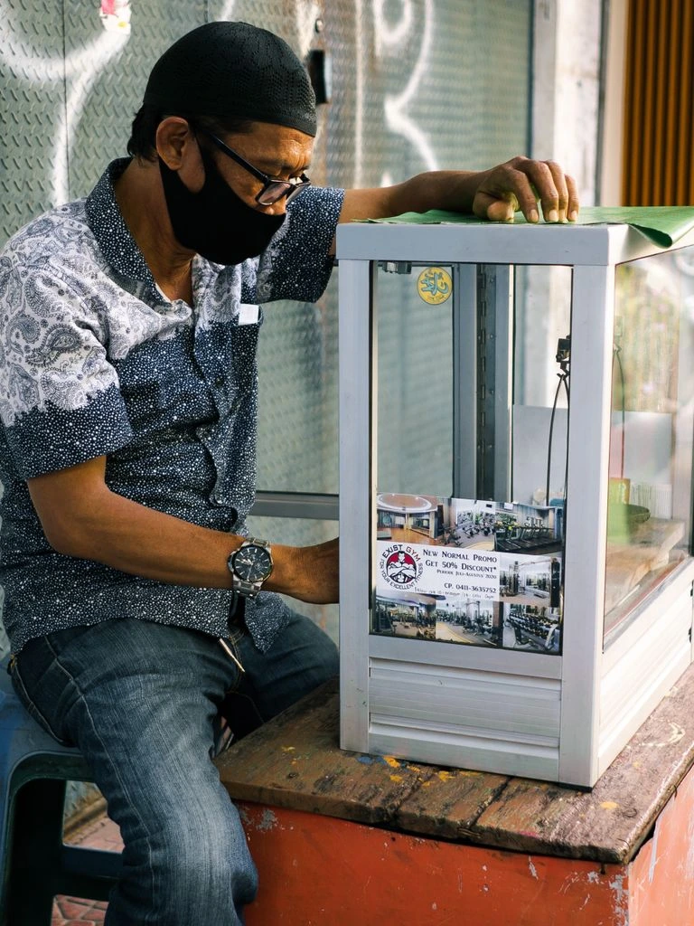 A forex bureau in central Accra displays USD and EUR exchange rates on a glass board.